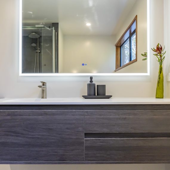 Bathroom transformation with flair featuring dark grey VAUCLUSE MOON NIGHT tiles, sleek contemporary vanities, and brushed nickel tapware, creating a luxurious and functional modern space.